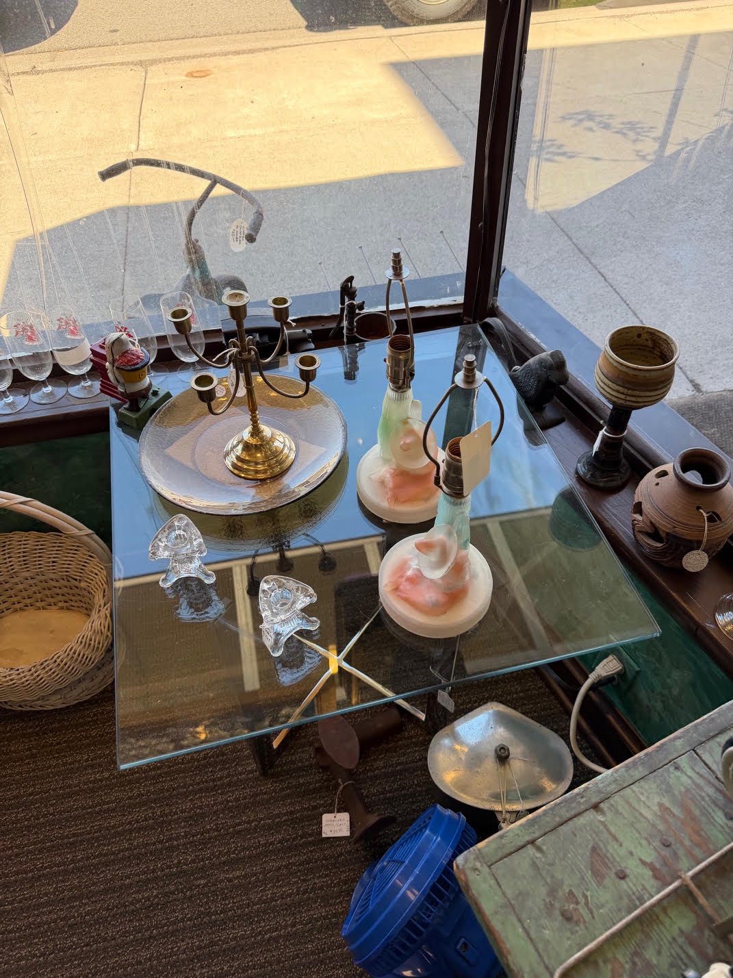 Antique lamps and pottery in the window.